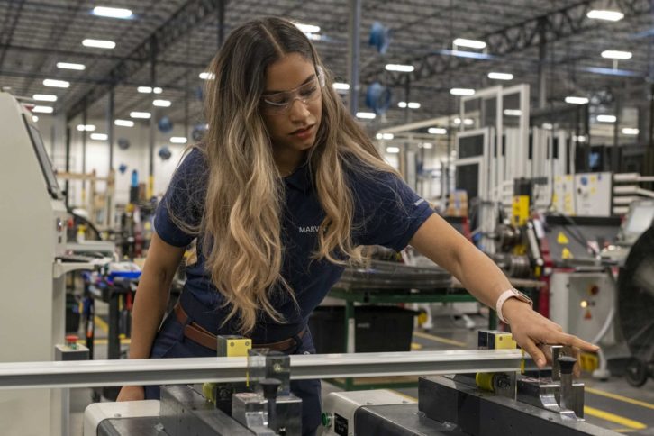 Woman works in manufacturing facility