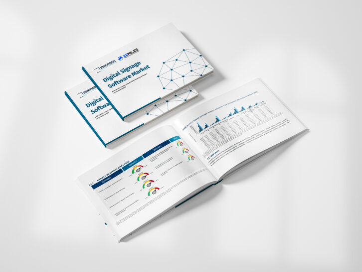 A stack of printed reports rests on a white background with filtered light. The report titles read, "Digital Signage Software Market" and credit Emergen Research & 22Miles. One report booklet is open to a page that shows charts of research findings.
